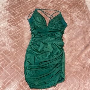 Figure-flattering dark emerald green satin homecoming dress.